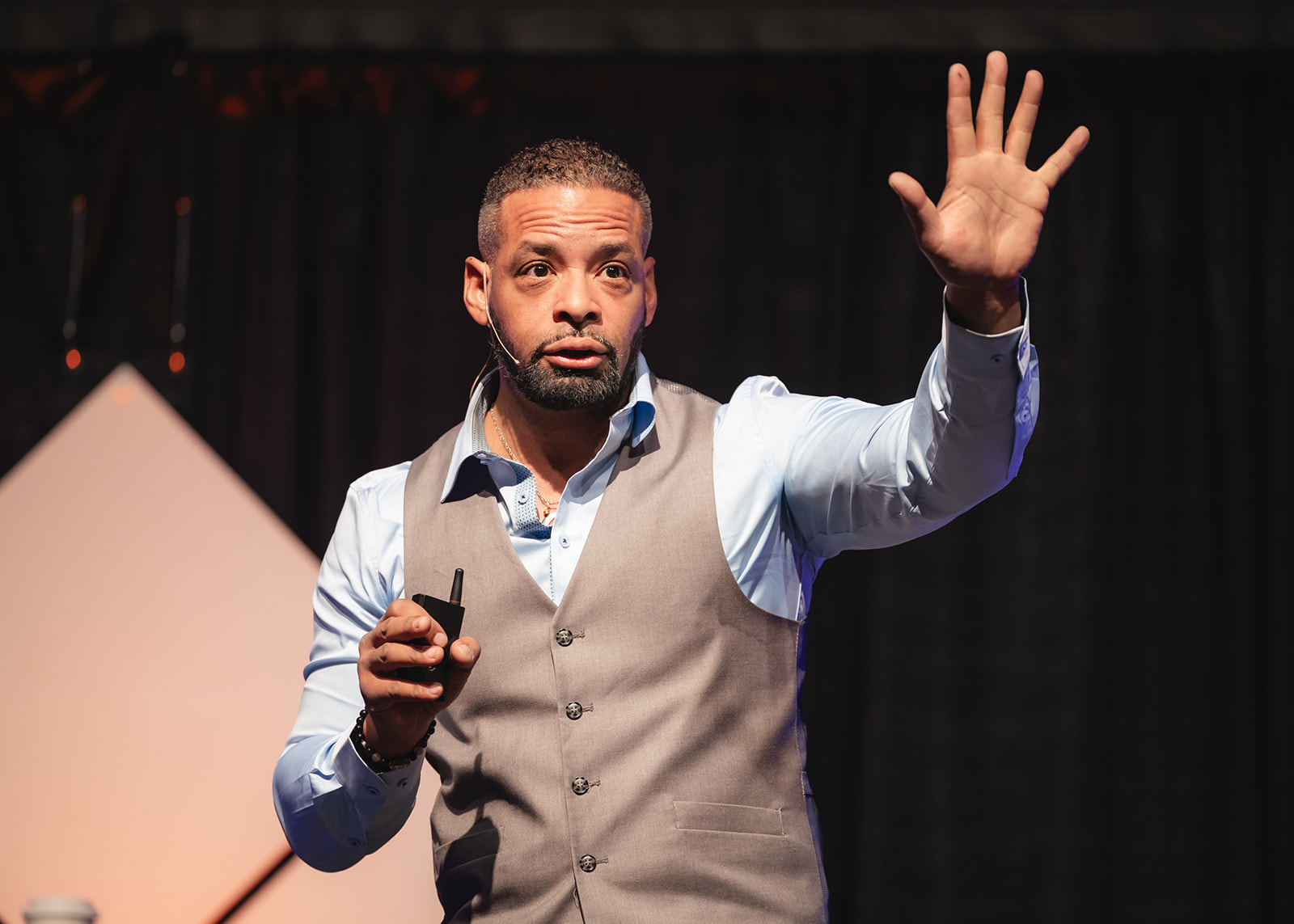 Dr. Stephen Crawford demonstrating vocal power while speaking from the stage
