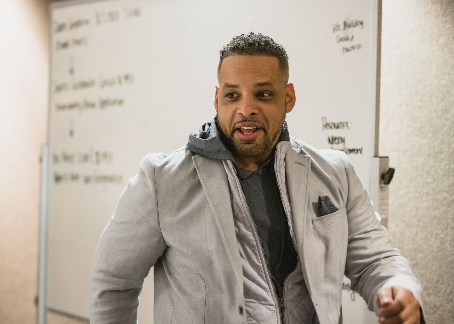 Dr. Stephen Crawford teaching in front of a whiteboard in a classroom setting